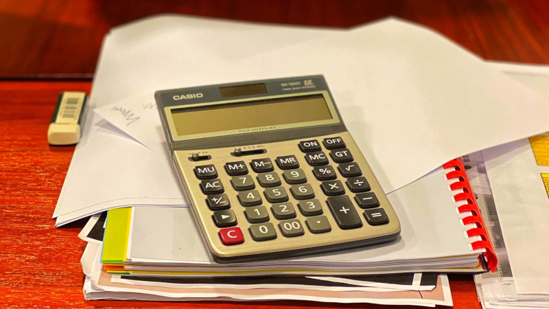 A calculator on top of some paper documents 