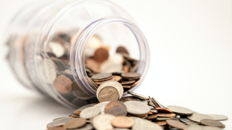 Jar with coins spilling out