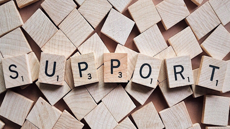 Scrabble tiles spelling the word support