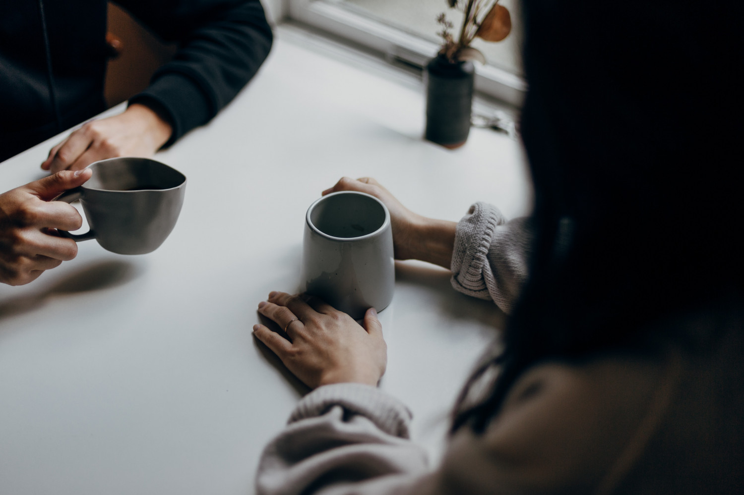 People talking with a cup of tea