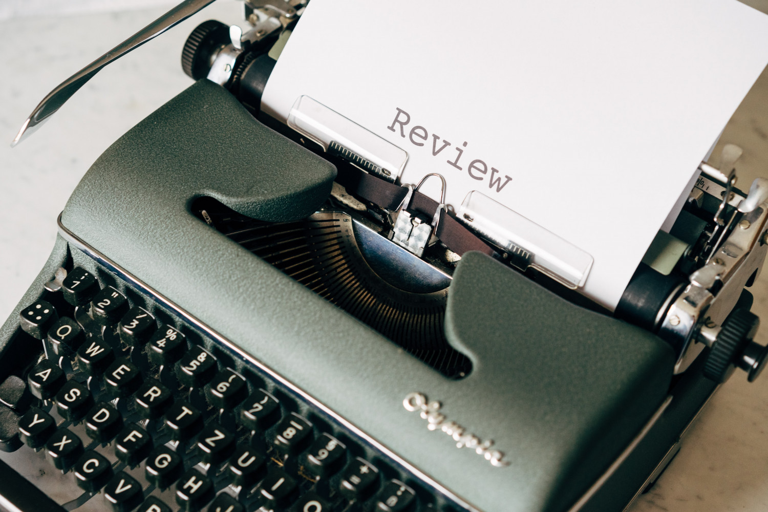 Typewriter typing the word 'review'