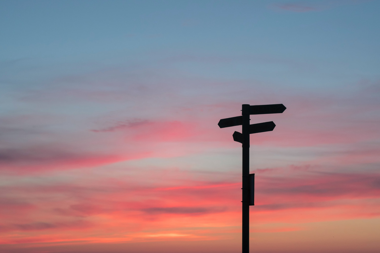 Silhouette of a road sign with a sunset background 