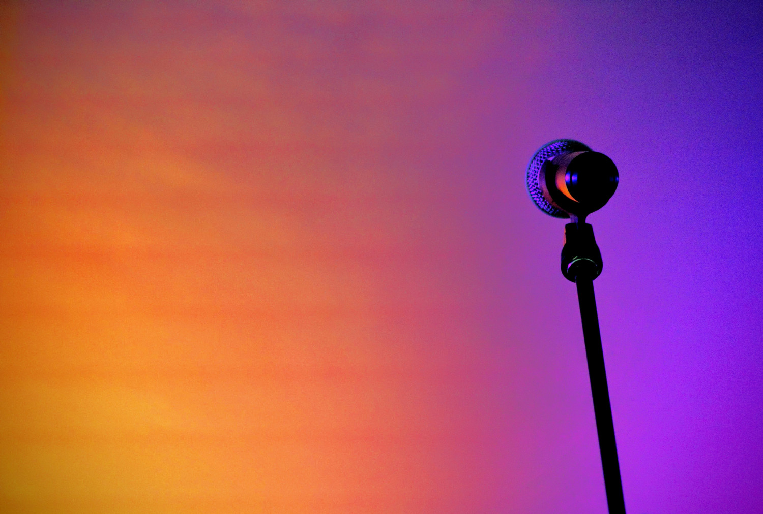 A microphone with a colourful background