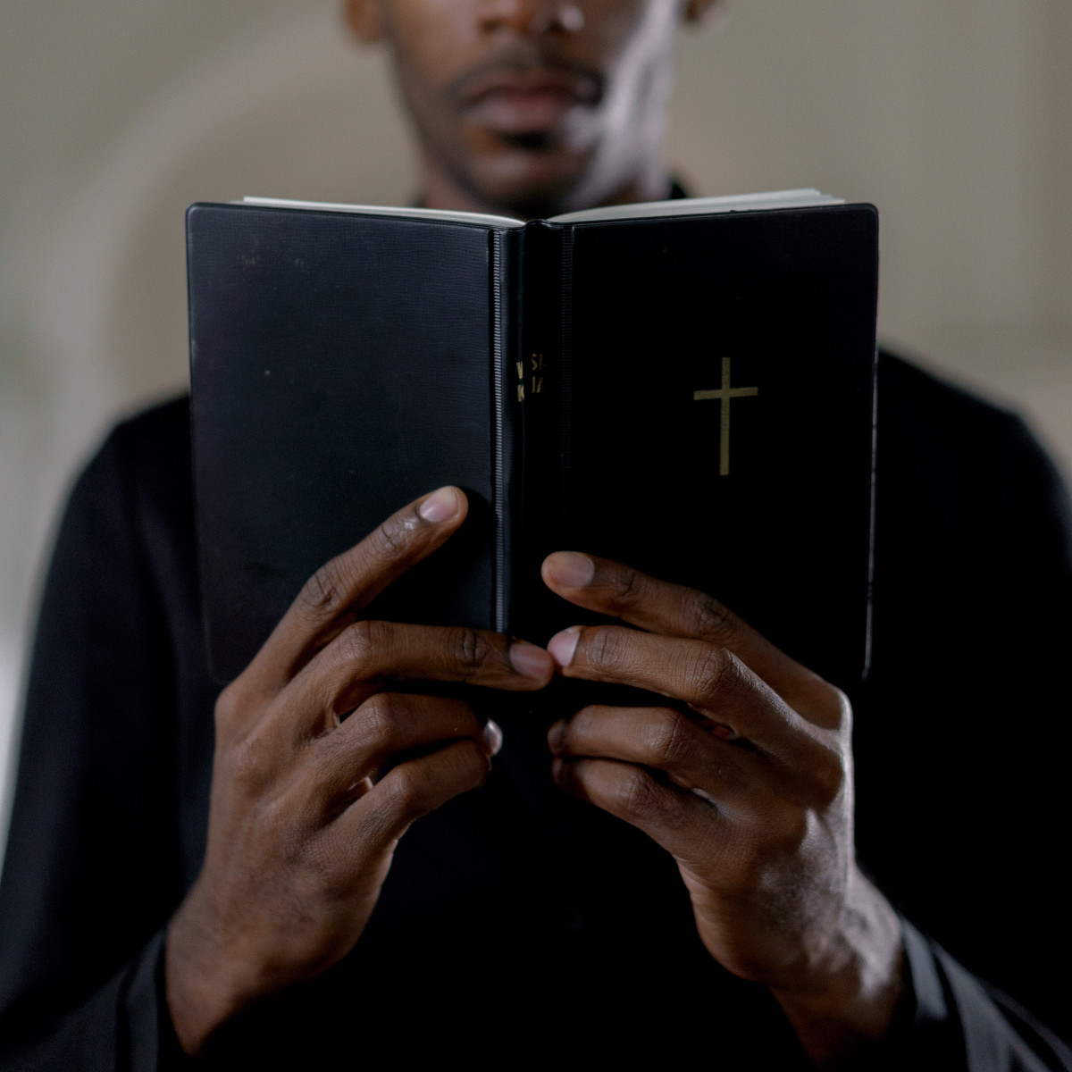 A person holding an open Bible