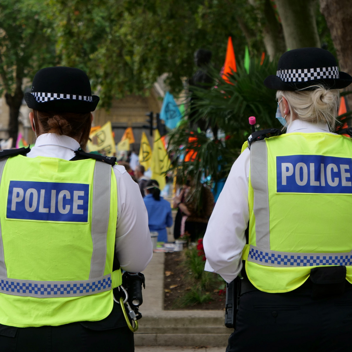 Two police officers walking down the street