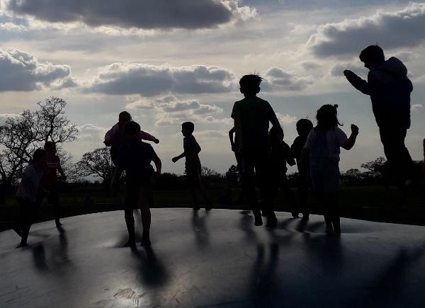 Children jumping on a trampoline 