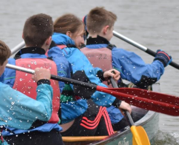 People rowing on a boat together