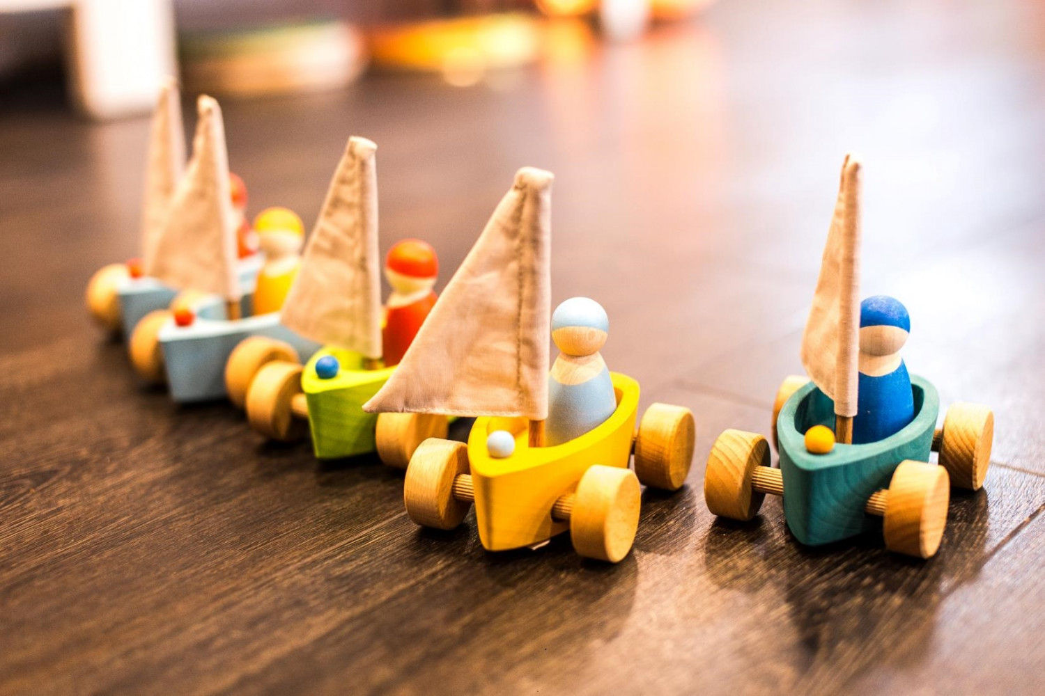 Wooden toys of people in boats 